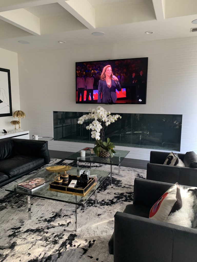 Wall-mounted TV installed over a fireplace by AudioVideoKing